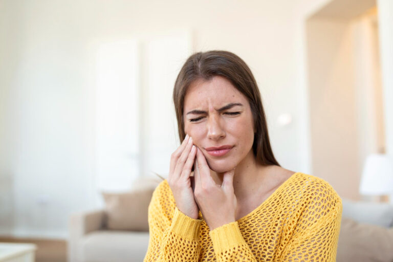 young woman suffering from wisdom teeth pain